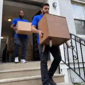 Professional movers handling furniture and boxes with expert care - Flat Moving Service