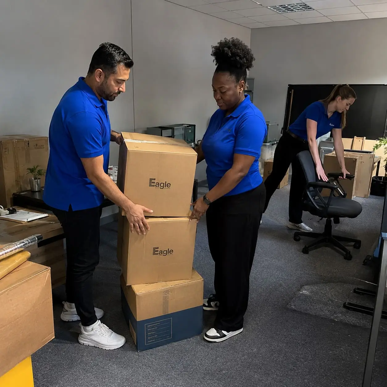 Professional office relocation team packing boxes – Packing Services