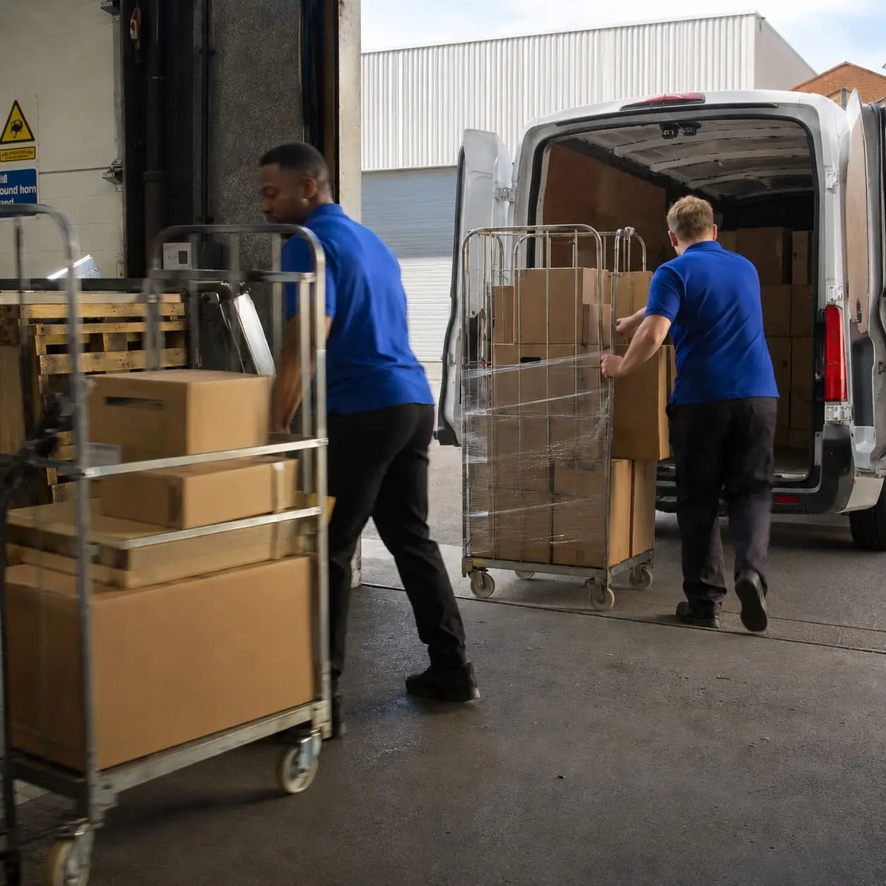 Removal team moving boxes into delivery van – Removal Services