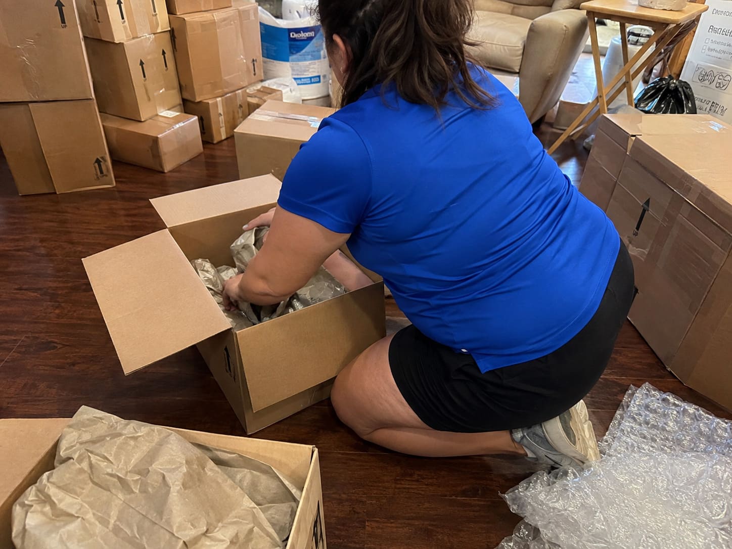 Professional packing specialist organising household belongings into sturdy removal boxes