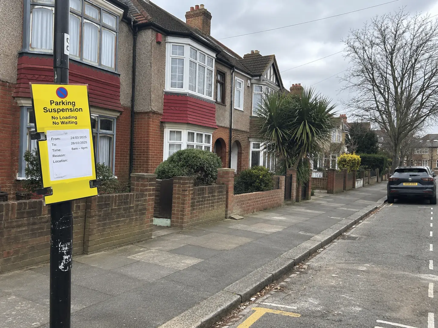 Suspended parking bay with Merton Council signs outside a Wimbledon home